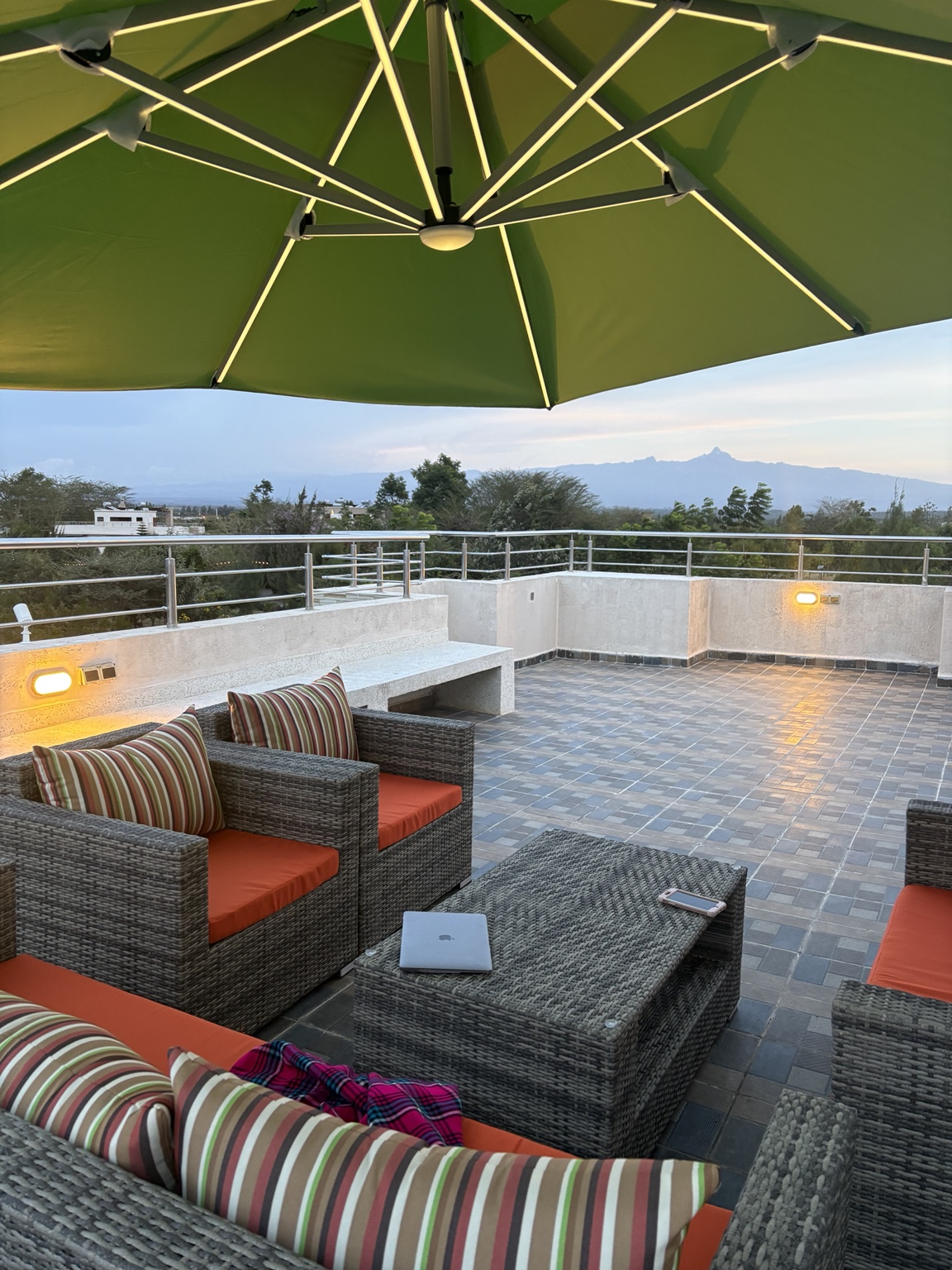 Rooftop outdoor lounge under umbrella